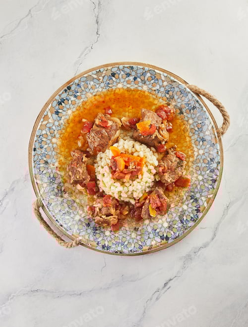 Preview: Roast beef and millet porridge on plate on wooden board