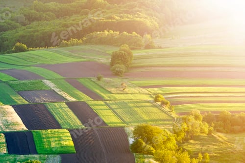 Preview: Beautiful peaceful multicolored patched aerial view of dark plowed and green fields