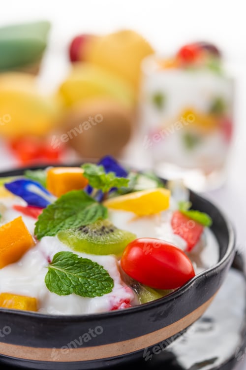 Preview: Fruit salad in a bowl on the wooden floor.