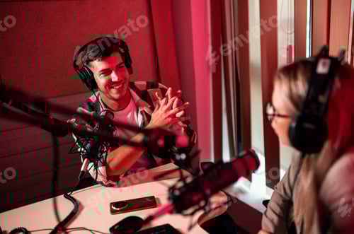 Preview: Female podcaster making podcast with young man from her studio.