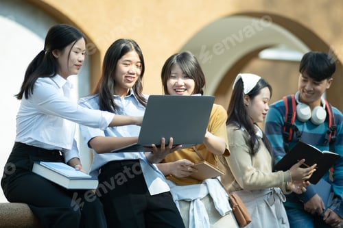 Preview: Group of students studying on campus outdoors