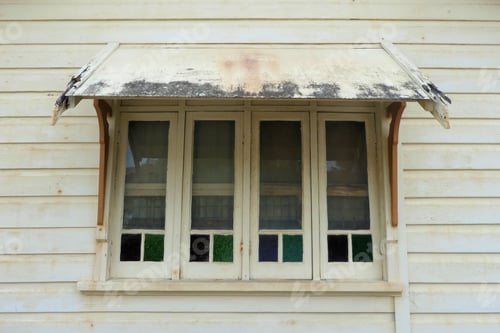 Preview: Old stained glass windows on weathered house