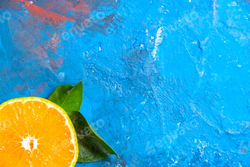 Preview: top half view cut orange on blue background free space