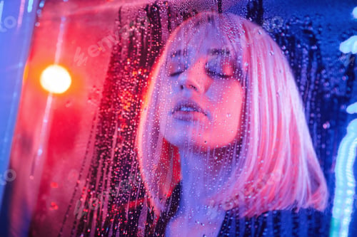 Preview: Eyes are closed. Stylish woman with white hair is behind wet transparent plastic sheet