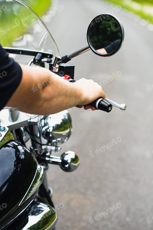 Preview: Close up on dirvers hand on a motorcycle