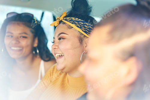 Preview: Three friends sharing a laugh inside a car on a sunny day