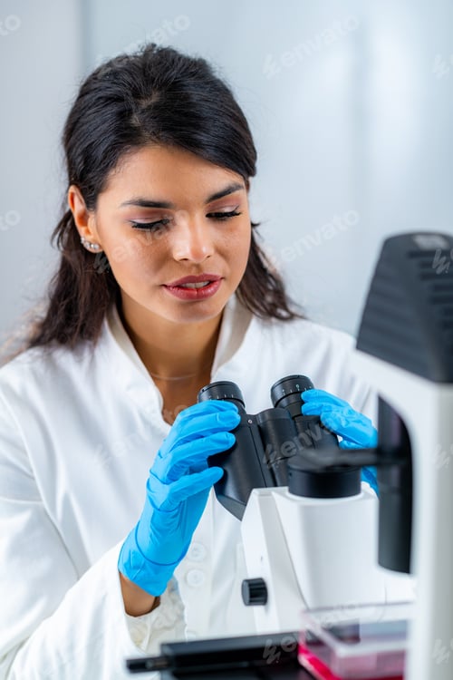 Preview: Woman Using Microscope in Lab, Wearing Blue Gloves