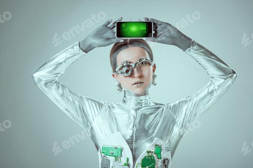 Preview: robot holding smartphone with business marketing graphs and looking at camera isolated on grey,