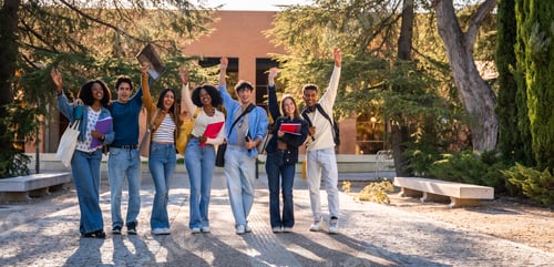 Preview: Diverse students raising hands celebrating success on university campus