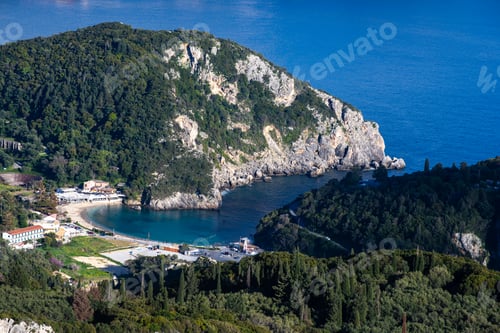 Preview: the small island has several green hills surrounding it and blue water