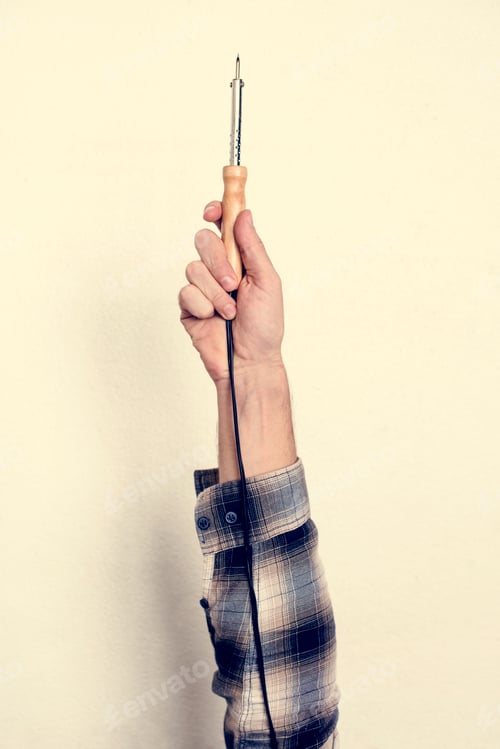 Preview: Hand holding equipment tool isolated on background