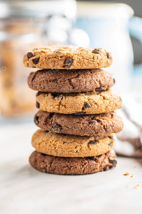 Preview: Stacked Chocolate Chip Cookies on a White Surface