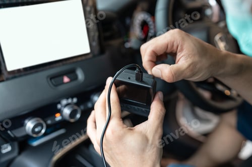 Preview: Hand of technician preparing and installing front camera car recorder