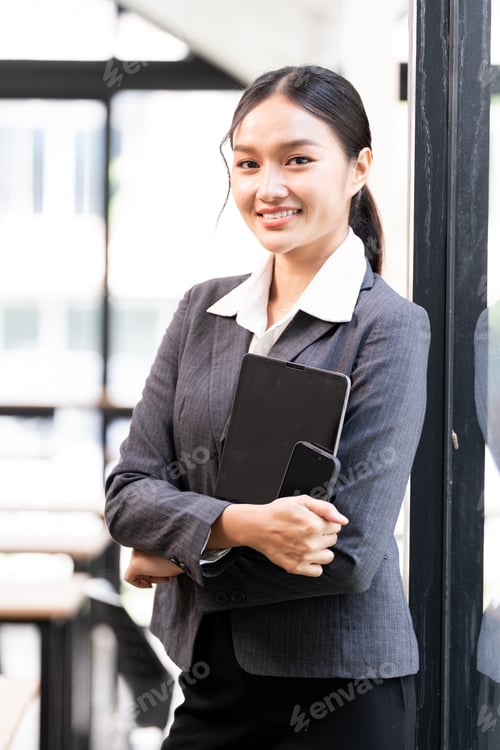 Preview: Portrait of happy businesswoman with touchpad in office, smiling to camera