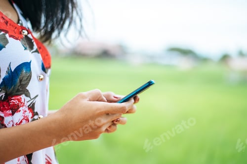 Preview: Young women wear colorful clothes and play a smartphone