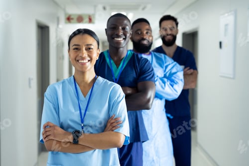 Preview: Portrait of diverse group of smiling healthcare workers standing in line in hospital corridor