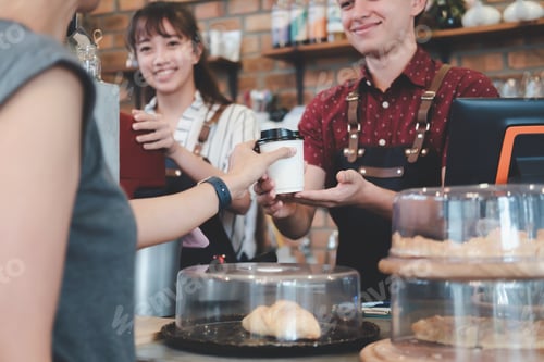 Preview: Young owner of coffee cafe service customer.