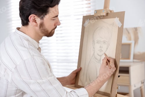 Preview: Man drawing portrait with pencil in artist's studio