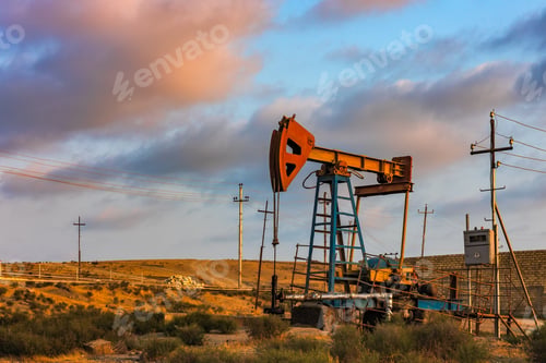 Preview: Oil rig pump against a colorful sunset sky