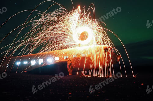 Preview: Abandoned DC bomber with steelwool and lights under some northern lights