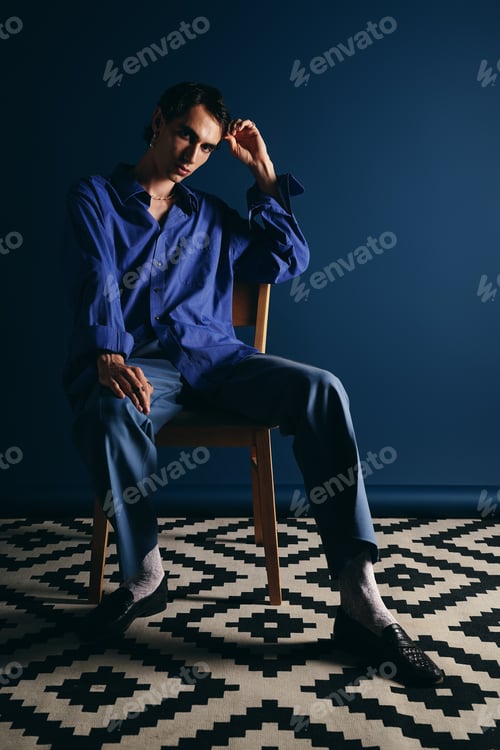 Preview: Stylish man poses in a modern setting showcasing contemporary fashion and charm