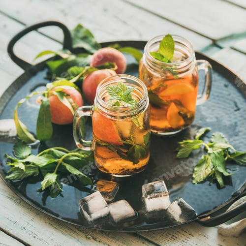 Preview: Summer refreshing cold peach ice tea on tray, square crop