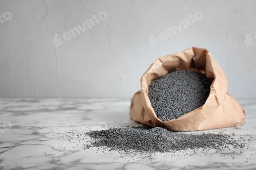 Preview: Poppy seeds with paper bag on table. Space for text