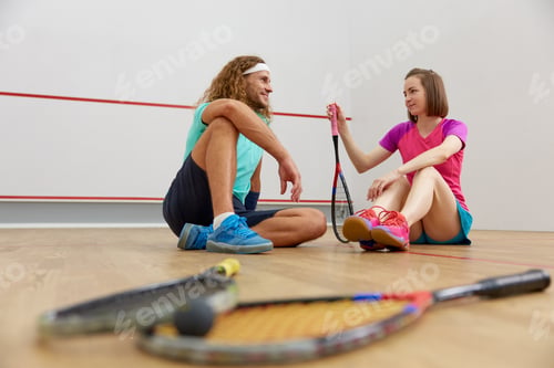 Preview: Male and female squash players taking break after the game