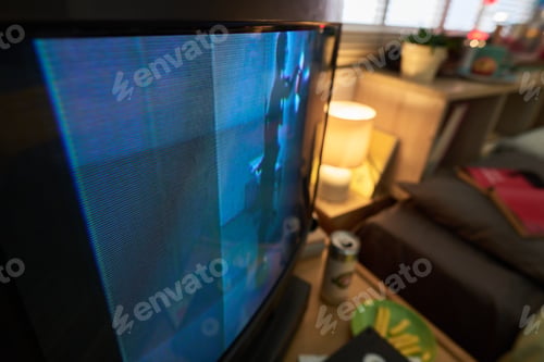 Preview: Watching Television in Cozy Living Room with Dim Lighting