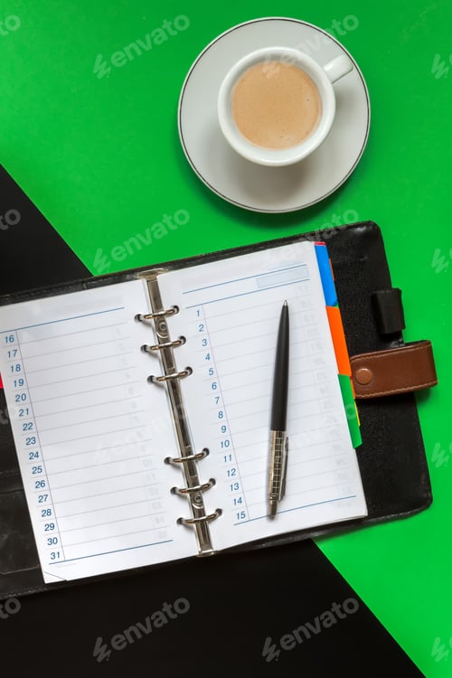 Preview: Black green office desk table with blank notebook, computer keyboard and other office supplies
