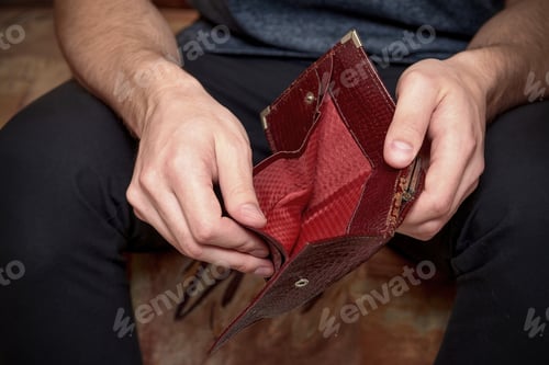 Preview: Close-up of an empty wallet in the hands of a man