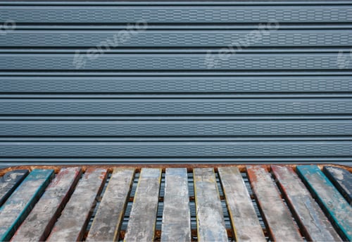 Preview: Old wooden table in front of the steel shutter door