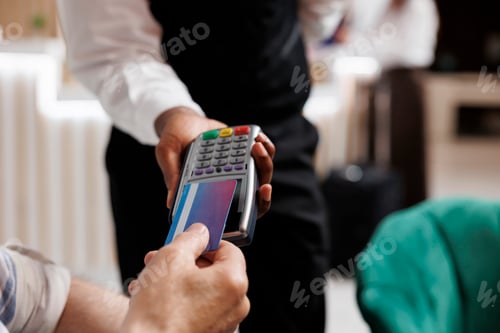 Preview: Man making cashless payment at hotel