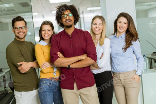 Preview: Group of young excited business people standing in office