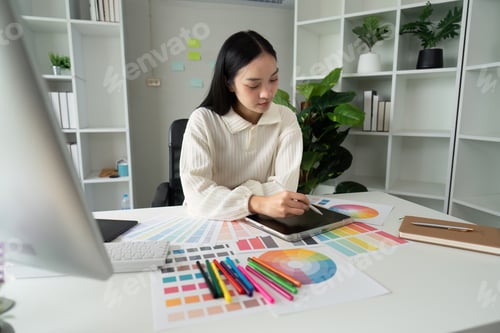Preview: Graphic or UI designer work on computer laptop and with tablet after brainstorming unique design