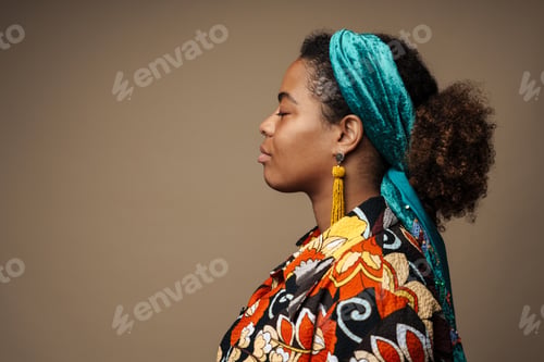 Preview: Young black woman wearing headband posing in profile
