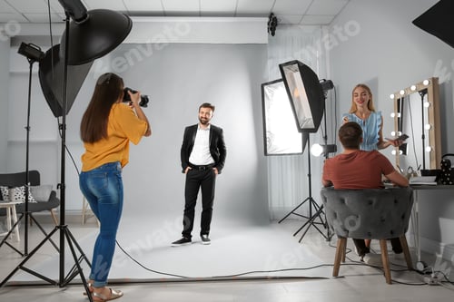 Preview: Professional team working with model in photo studio