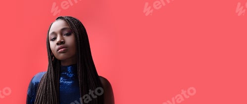 Preview: A lady confidently poses before a vibrant coral backdrop