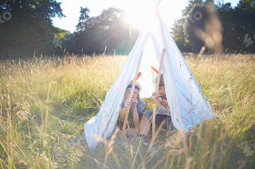 Preview: Two young boys sitting inside a teepee
