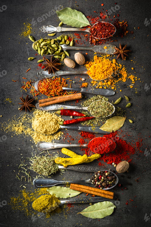 Preview: Spices in spoons on black background.