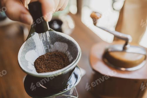 Preview: Professional hipster barista making drip brewing, filtered coffee or pour over coffee with hot water