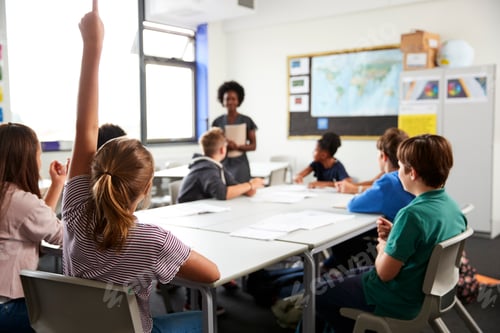 Preview: High School Students Raising Hands To Answer Question Set By Teacher In Classroom