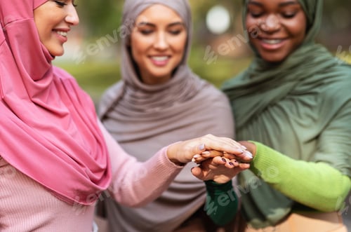 Preview: Group Of United Arabic Ladies Holding Hands Standing Together Outdoors