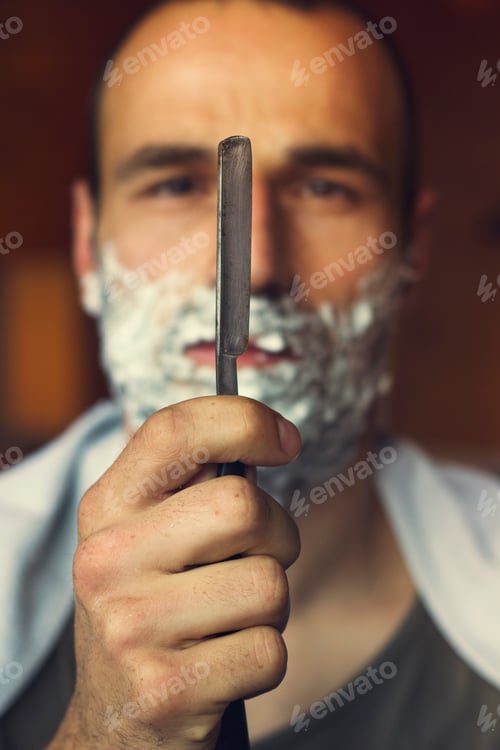 Preview: Young man holding straight razor