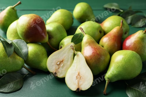 Preview: Fresh ripe pears and leaves on green wooden table, closeup