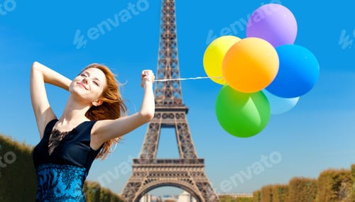Preview: Redhead girl with colour balloons on parisian Eiffel tower background.