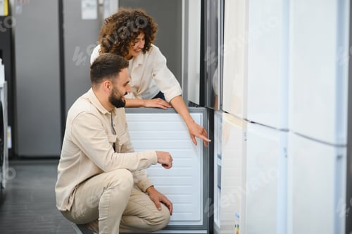 Preview: Couple choosing refrigerator in electronics store