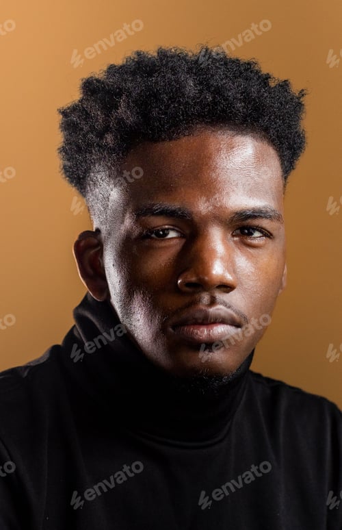 Preview: Vertical shot of an African American man on the ochre color background.