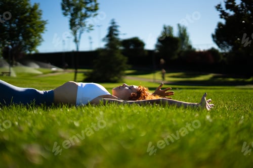 Preview: Woman exercising the pelvic floor with hypopressive exercises in a park in the morning