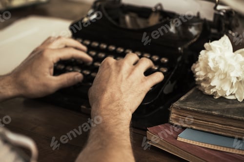 Preview: Young man's hands typing on an antique vintage typewriter